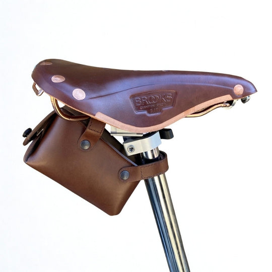 Brown leather bicycle saddle bag on a white background velcro attachment