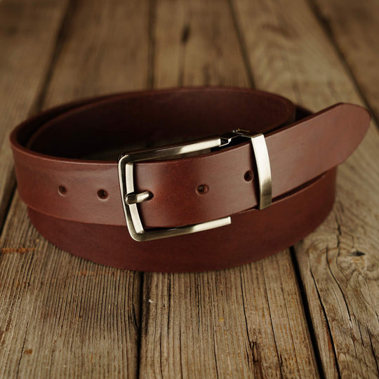 Brown leather belt on wooden background