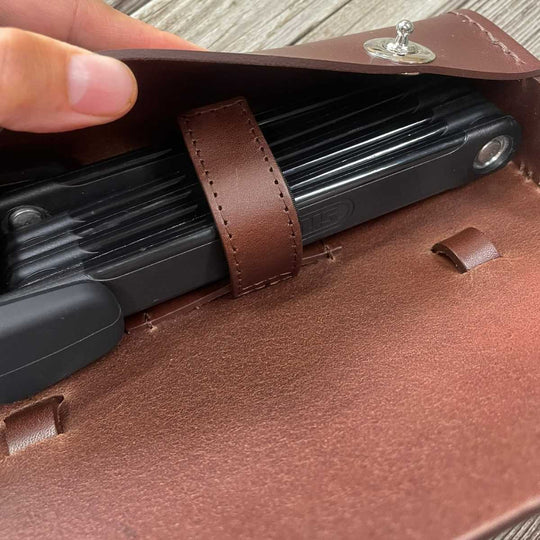 Close-up of a brown leather traditional saddle bag with strap for ABUS