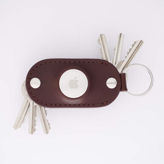 Brown leather airtag key organizer with keys on a white background with car key adapter