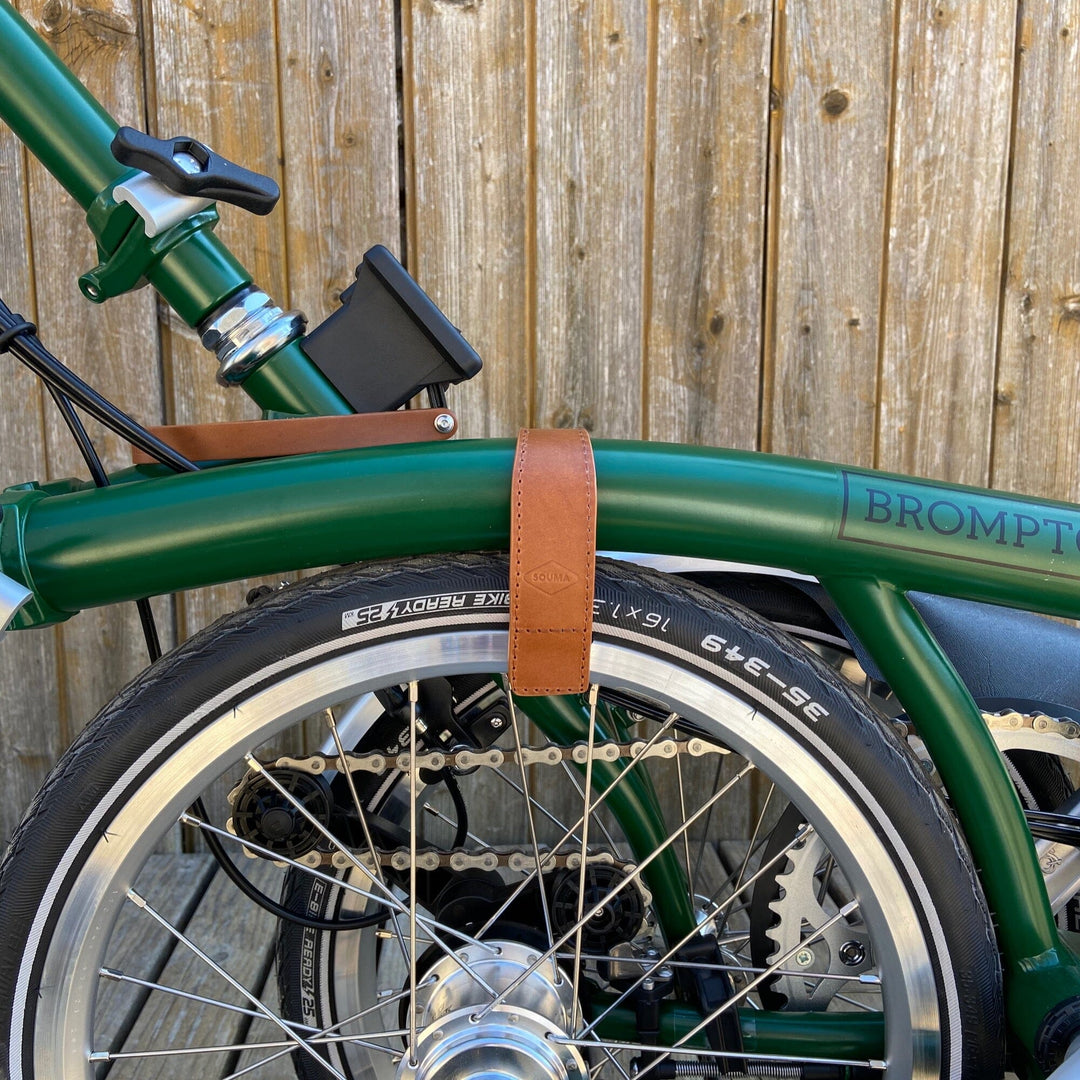 Honey version of Brompton leather wheel frame strap and trousers strap 2in1 Brompton bicycle can be seen partially infolded