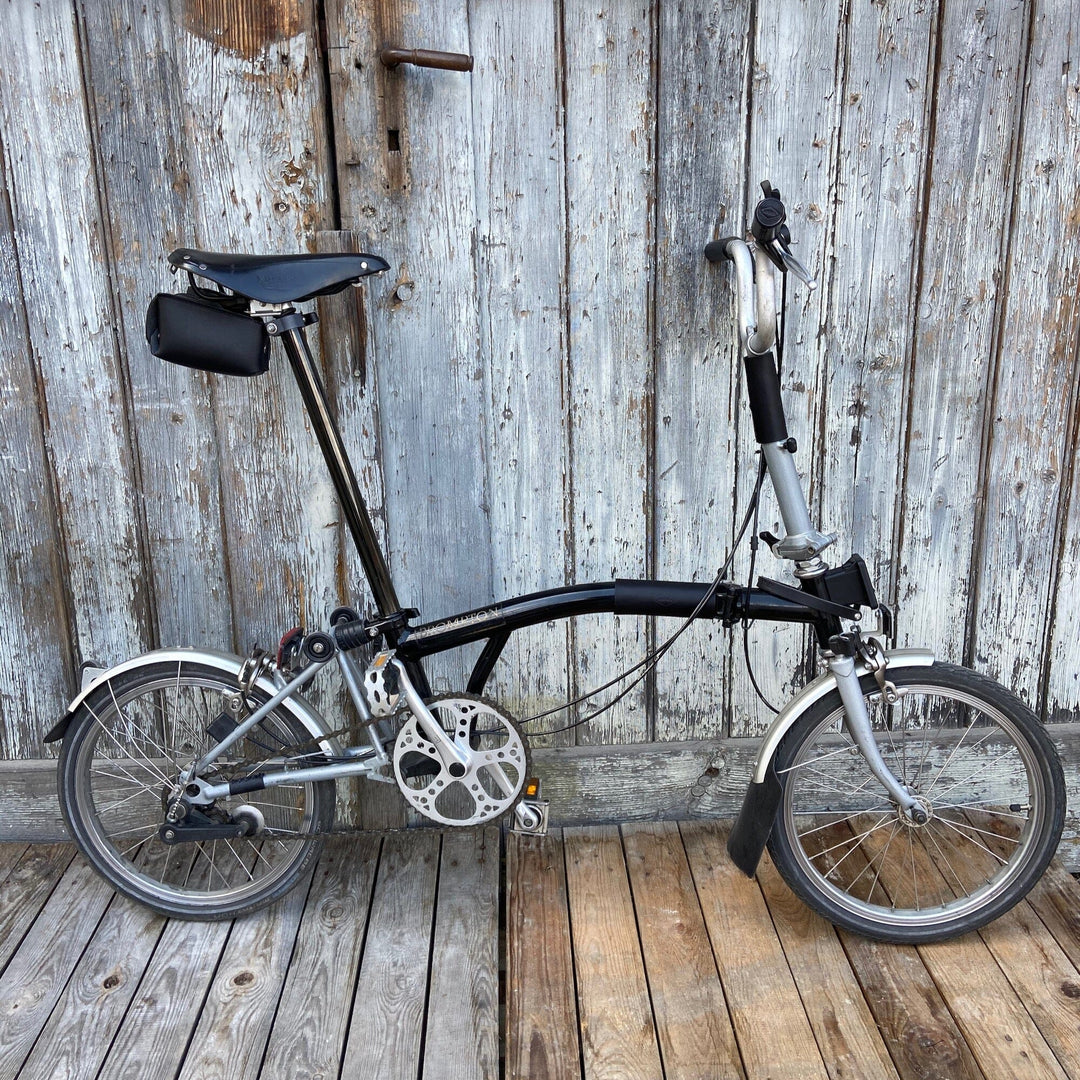 Brompton bicycle with Brompton accessories and saddle bag in black