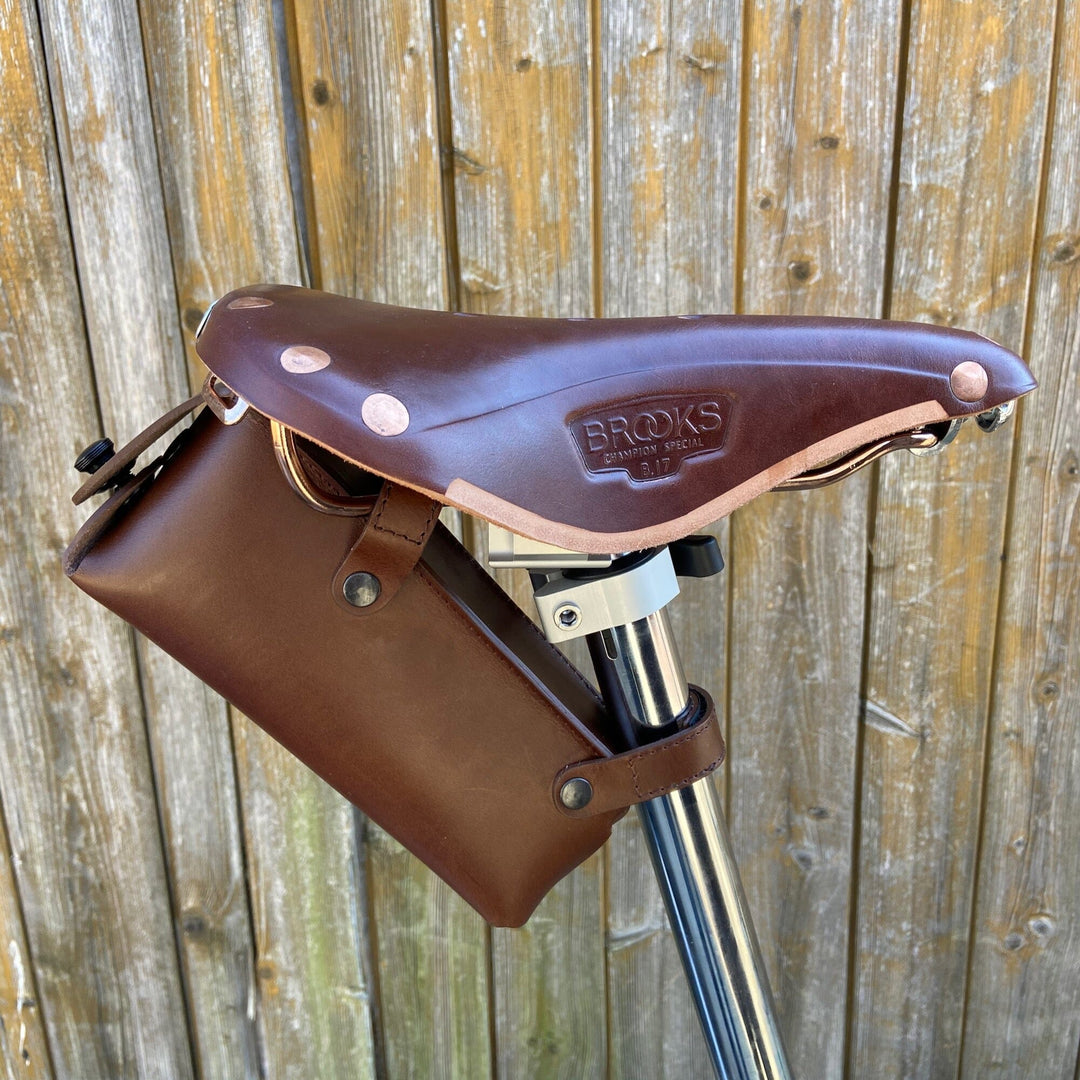 Brompton saddle bag brown with black hardware large on wooden background