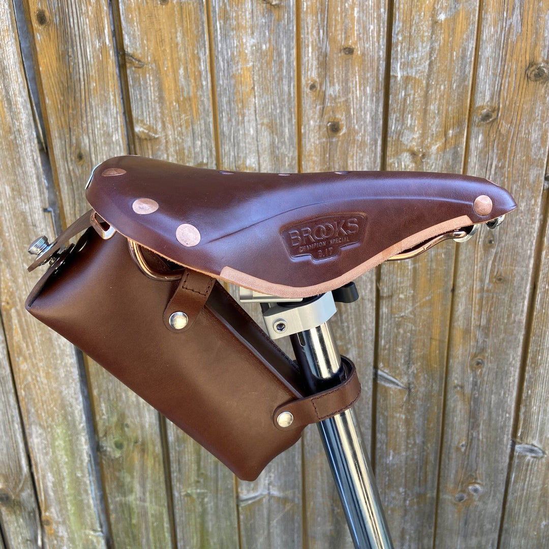 Brompton saddle bag brown with silver hardware large on wooden background