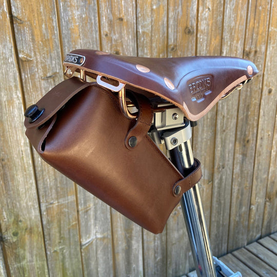 Brompton saddle bag brown with black hardware large on wooden background side view